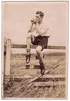 Alex playing mouth organ c1936